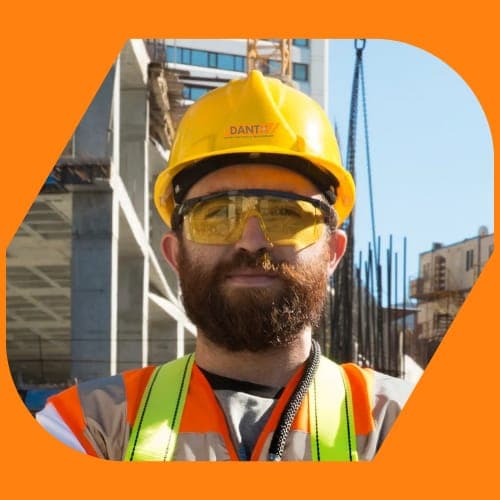 The Hard Hatters — a DantX crew member in branded hard hat and safety glasses