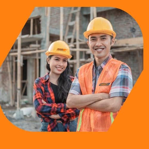 Two DantX crew members in branded hi-vis and hard hats on an Irish build site